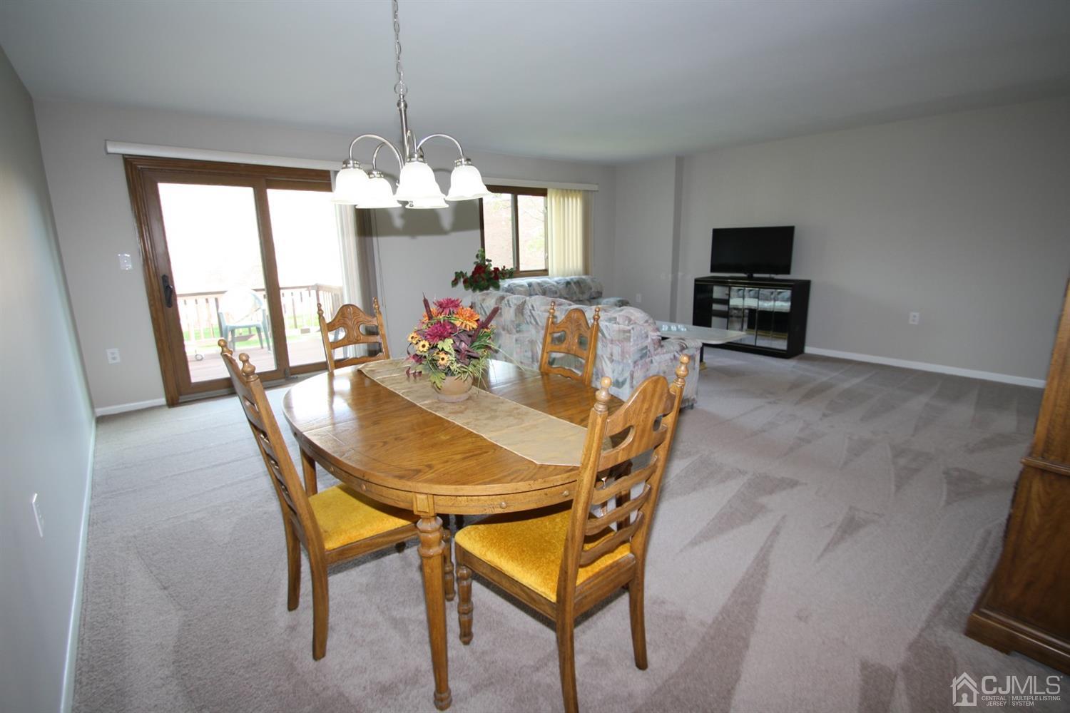 812 Robin Road Hillsborough, NJ 08844 - Photo 5 of 23 a dining room with furniture a chandelier and window