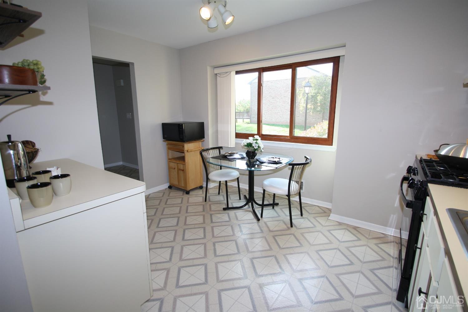 812 Robin Road Hillsborough, NJ 08844 - Photo 7 of 23 a view of a workspace with furniture and a window