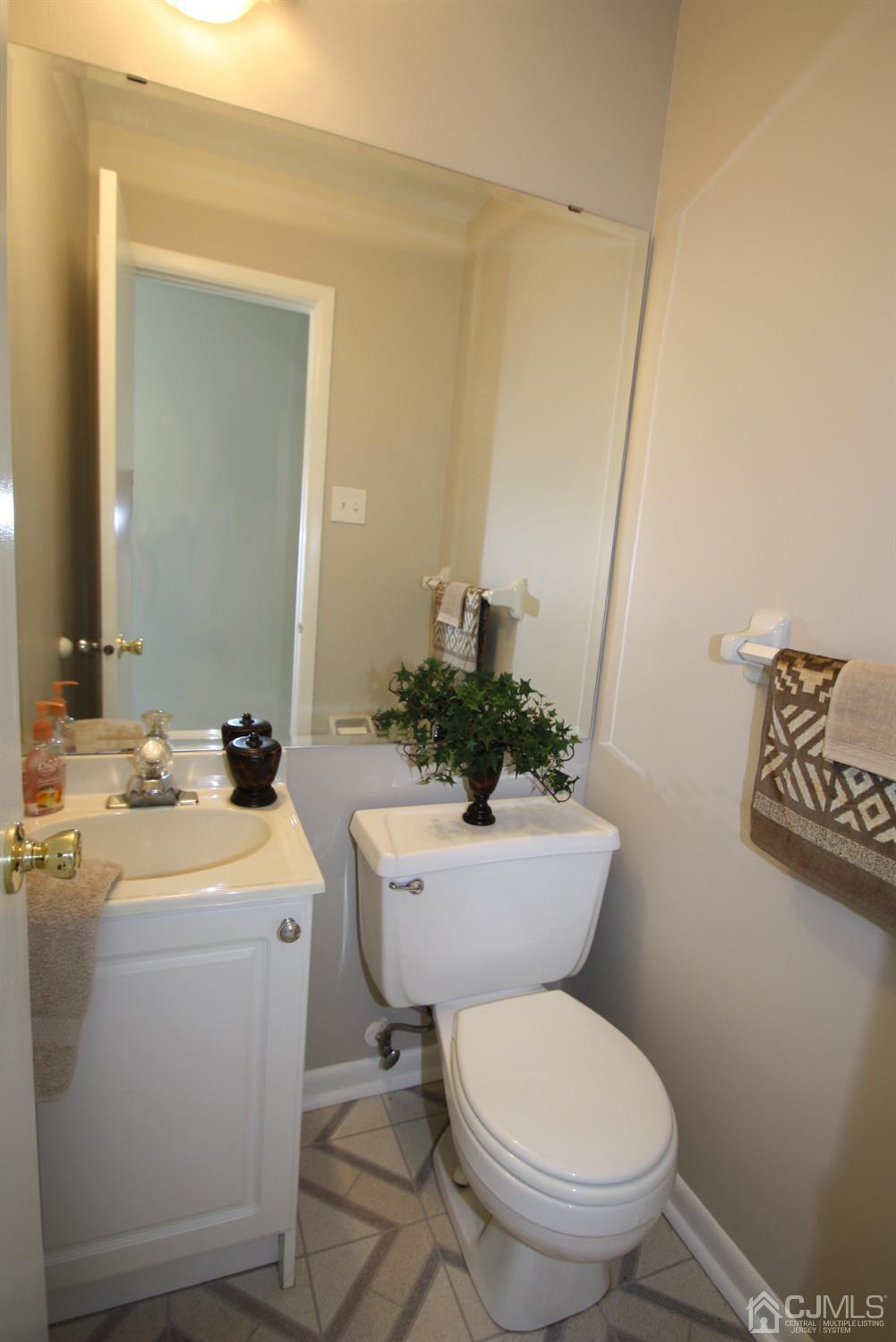 812 Robin Road Hillsborough, NJ 08844 - Photo 9 of 23 a bathroom with a toilet sink and mirror