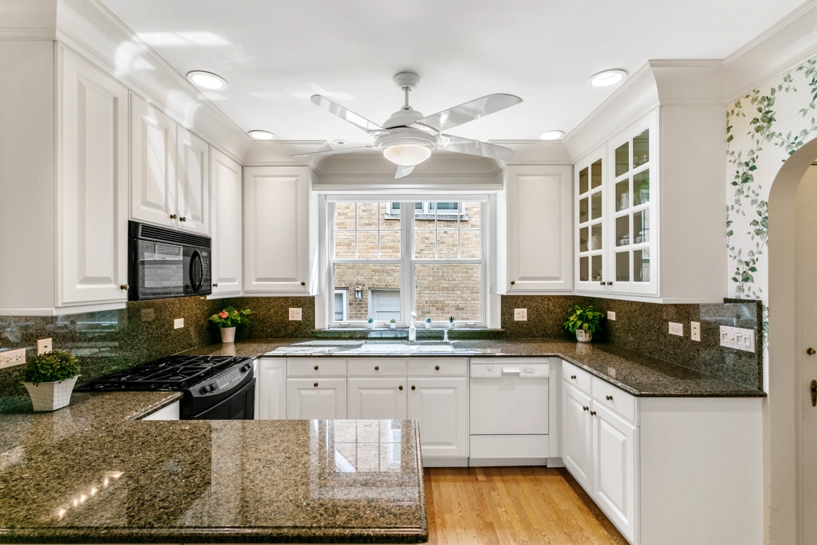 258 Southcote Road Riverside, IL 60546 - Photo 4 of 31 a kitchen with granite countertop a sink a counter top space appliances and cabinets