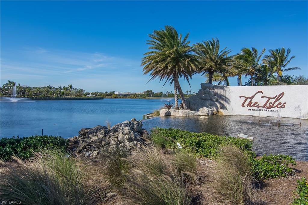 6552 Dominica Drive, Unit 101 Naples, FL 34113 - Photo 48 of 50 a view of a lake with a beach