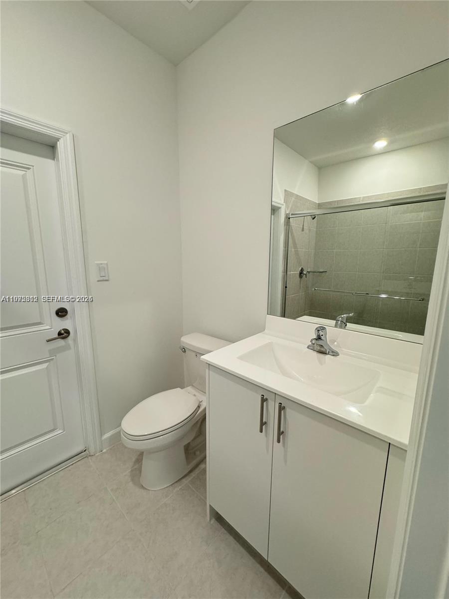 14894 Southwest 163rd Street Miami, FL 33157 - Photo 11 of 15 a bathroom with a sink toilet and shower