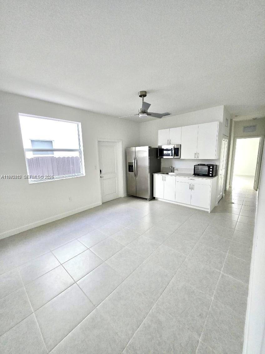 14894 Southwest 163rd Street Miami, FL 33157 - Photo 12 of 15 a large white kitchen with cabinets