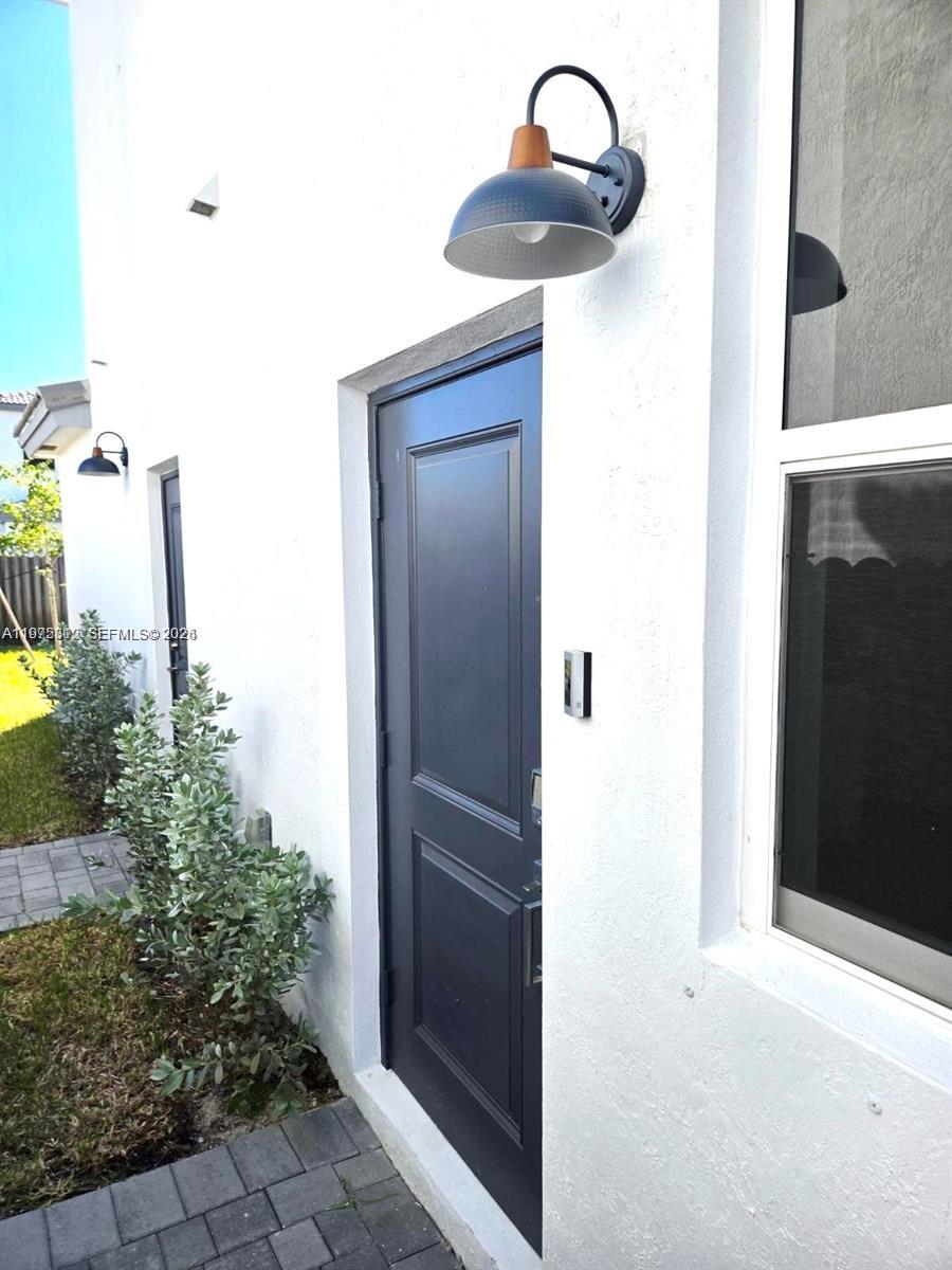 14894 Southwest 163rd Street Miami, FL 33157 - Photo 2 of 15 a close view of sliding door in the backyard