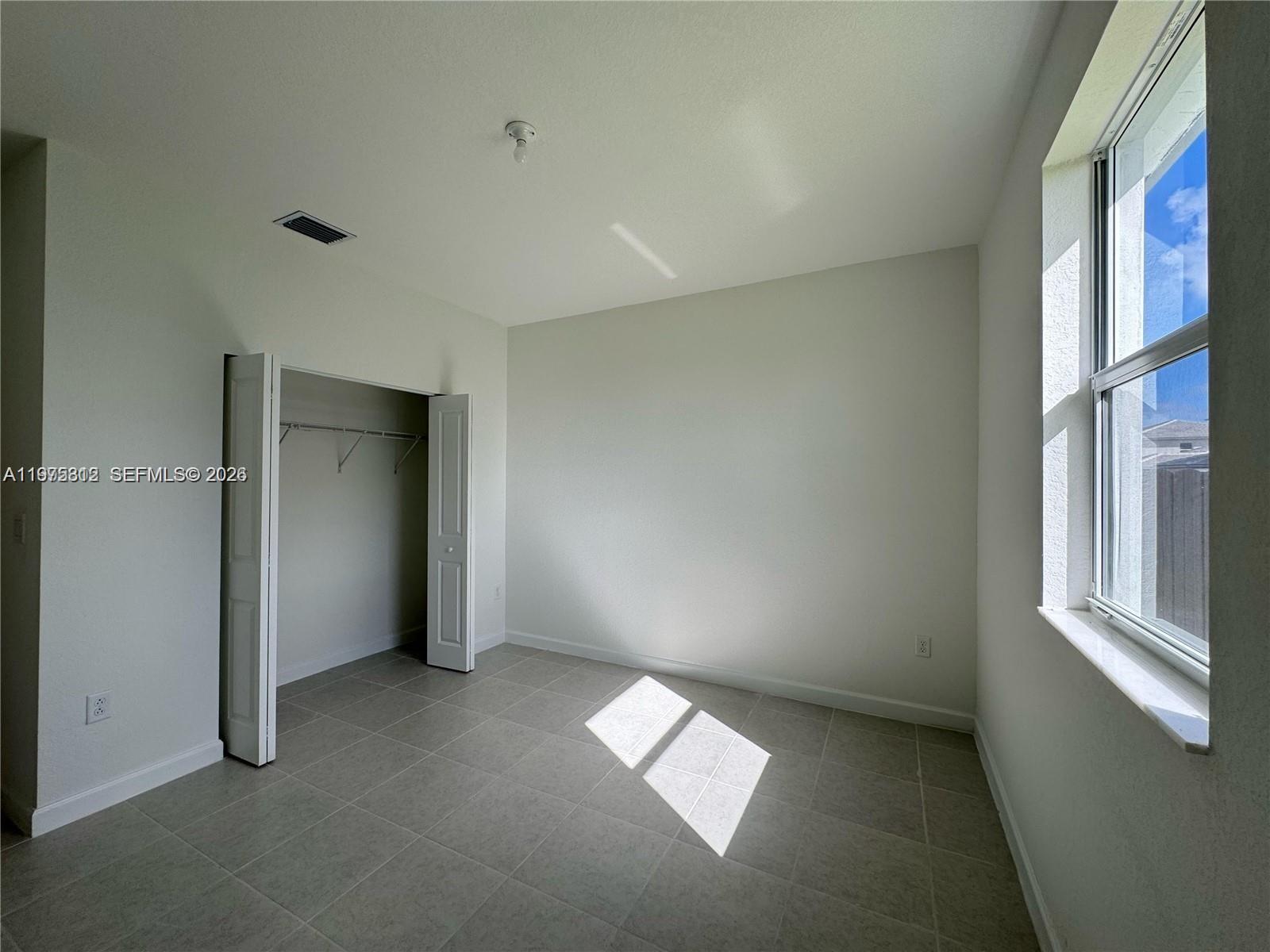14894 Southwest 163rd Street Miami, FL 33157 - Photo 5 of 15 an empty room with windows