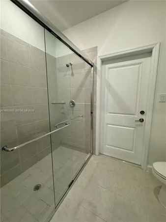 a bathroom with a shower and a toilet