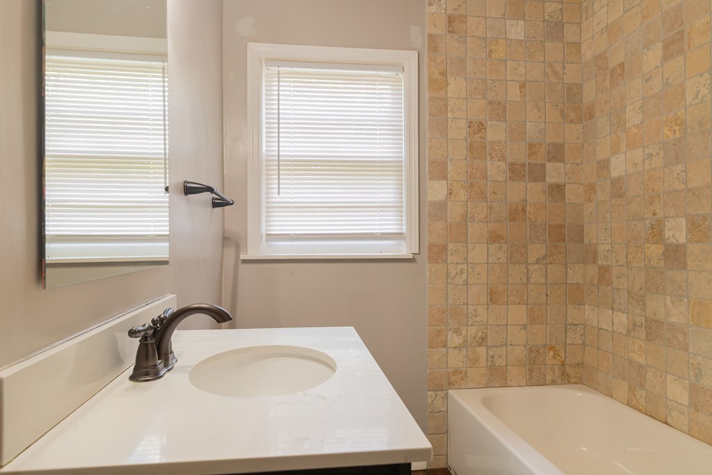 4214 17th Avenue Columbus, GA 31904 - Photo 13 of 15 a bathroom with a sink a bathtub and window