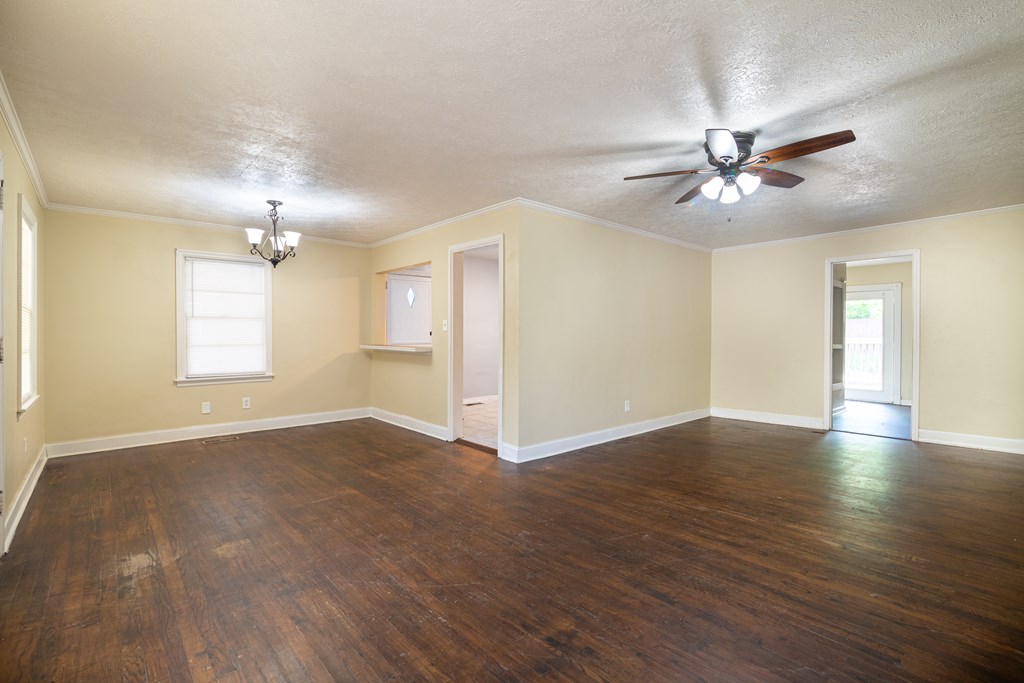 4214 17th Avenue Columbus, GA 31904 - Photo 3 of 15 a view of an empty room with window and wooden floor