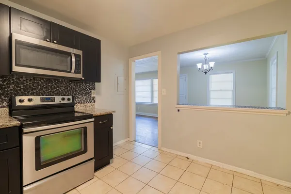 a kitchen with a stove and a microwave