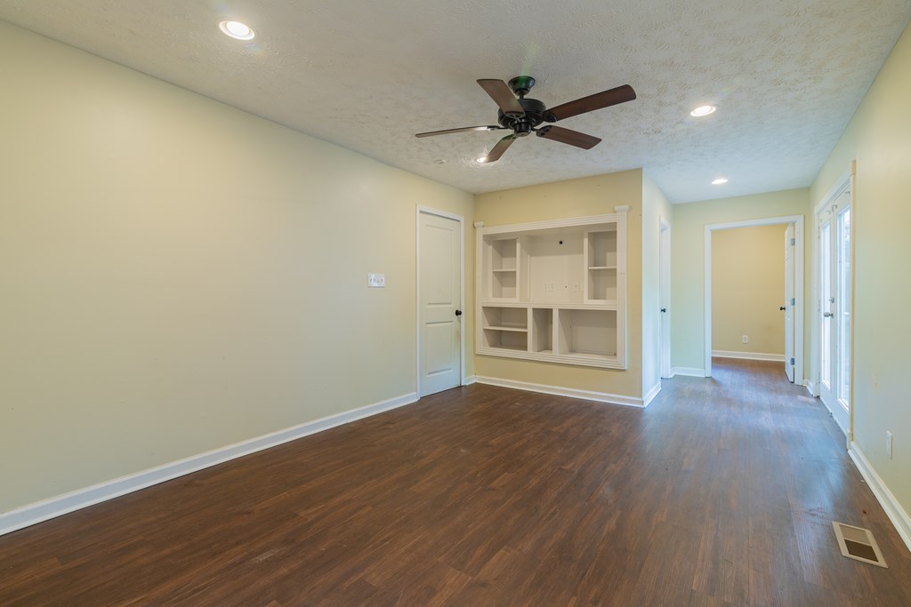 4214 17th Avenue Columbus, GA 31904 - Photo 9 of 15 a view of a livingroom with a ceiling fan hardwood floor and a ceiling fan