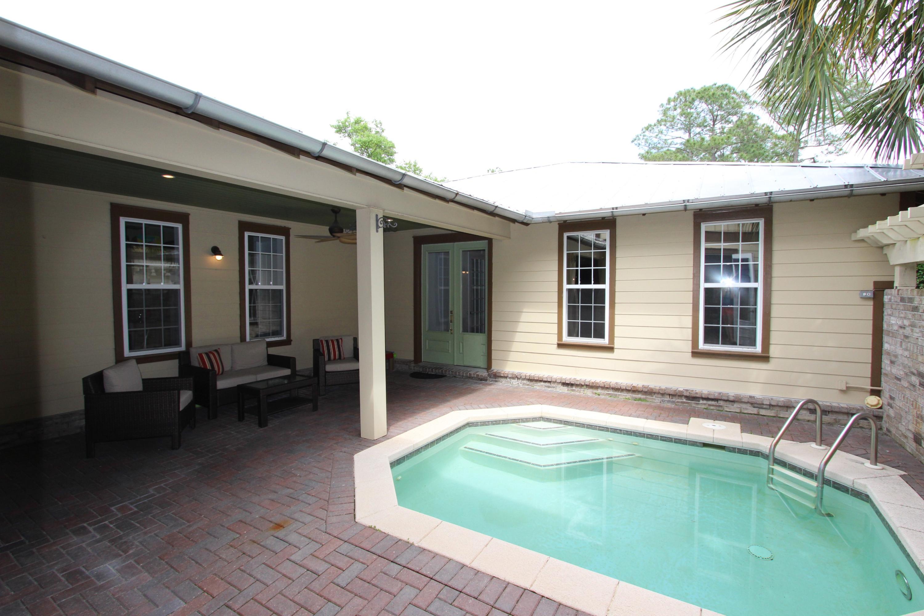 482 West Harborview Road Santa Rosa Beach, FL 32459 - Photo 3 of 48 a swimming pool with patio outdoor seating and yard