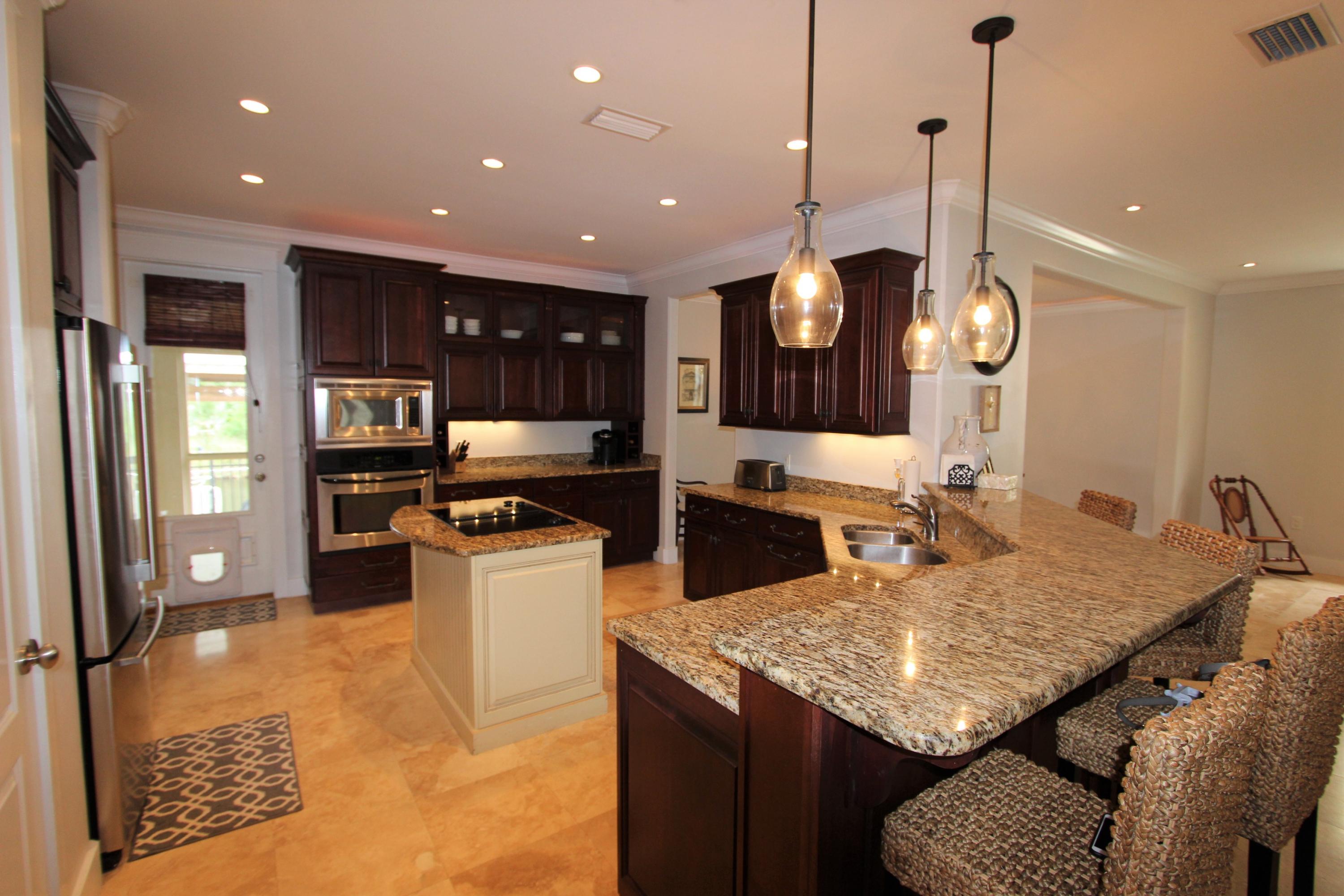 482 West Harborview Road Santa Rosa Beach, FL 32459 - Photo 8 of 48 a kitchen with a table and chairs