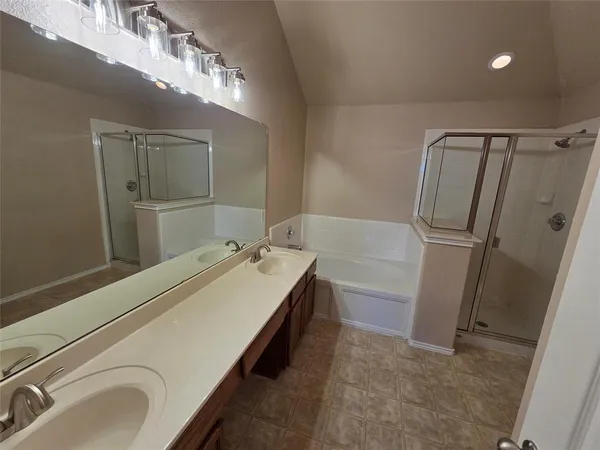 a bathroom with a double vanity sink and mirror