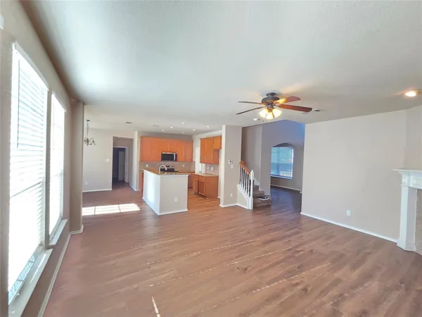 a view of a room with wooden floor and window