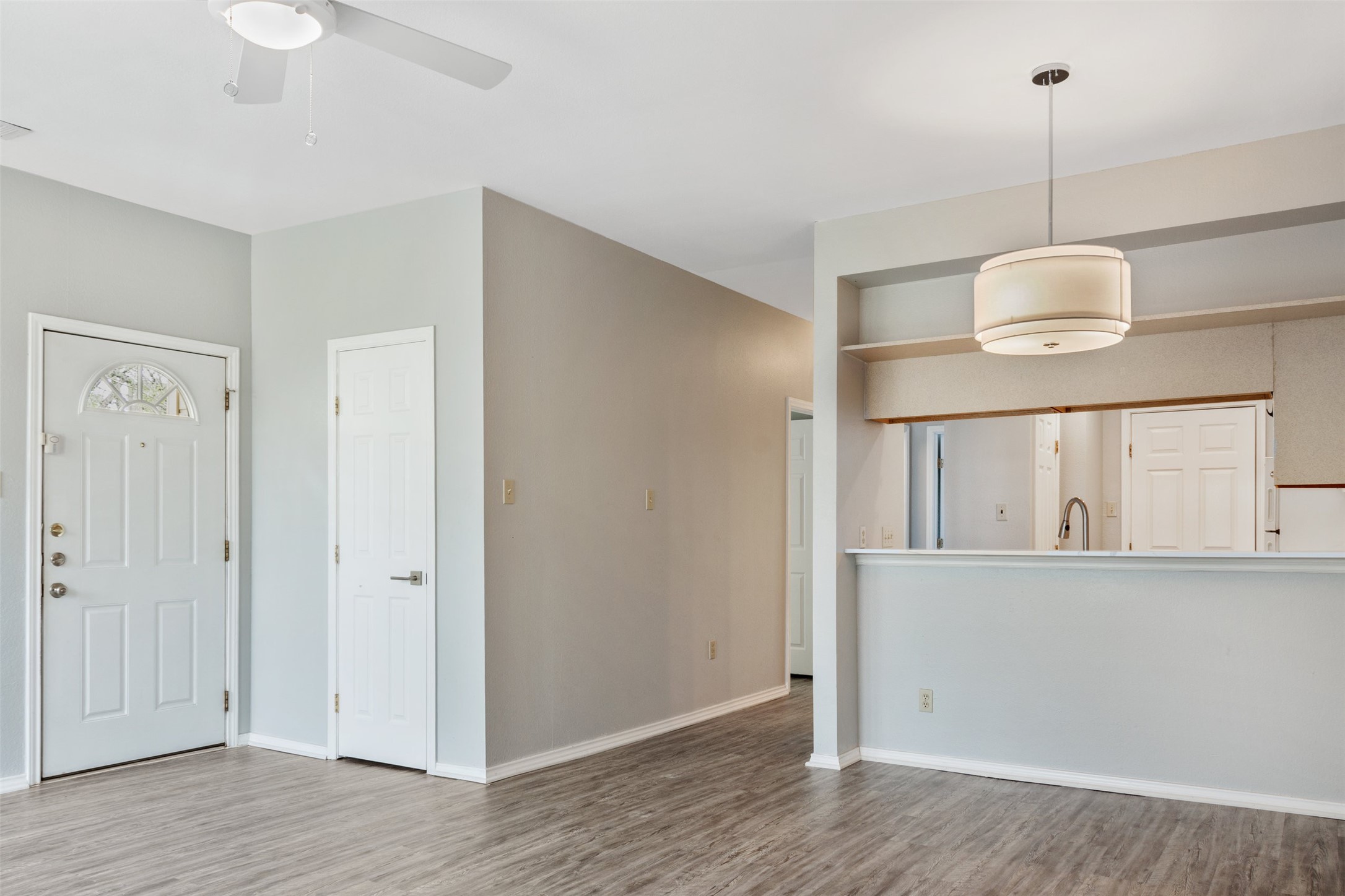 5303 Indio Cove, Unit A Austin, TX 78745 - Photo 3 of 15 a view of an empty room with wooden floor and a window