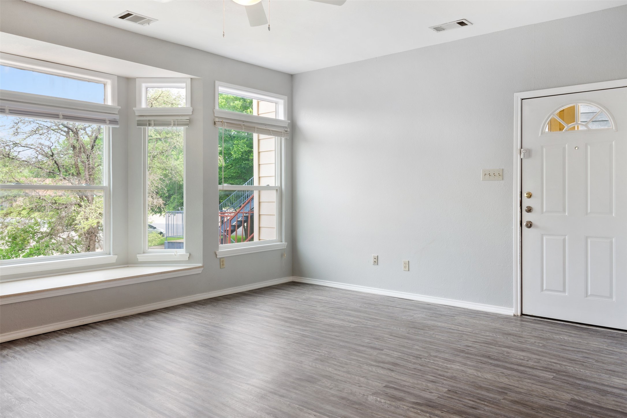 5303 Indio Cove, Unit A Austin, TX 78745 - Photo 4 of 15 a view of an empty room with wooden floor and a window