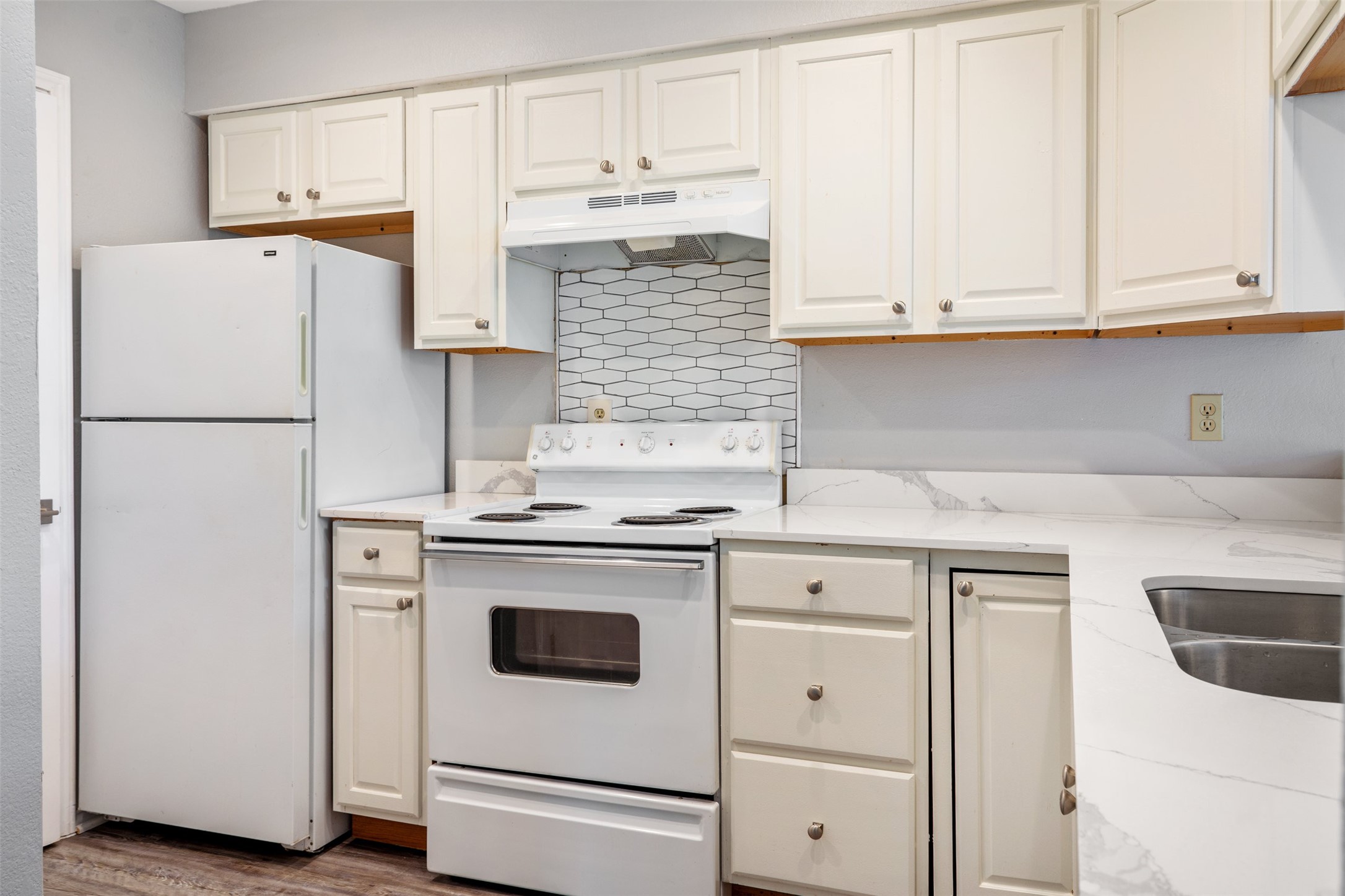 5303 Indio Cove, Unit A Austin, TX 78745 - Photo 7 of 15 a kitchen with white cabinets and white appliances