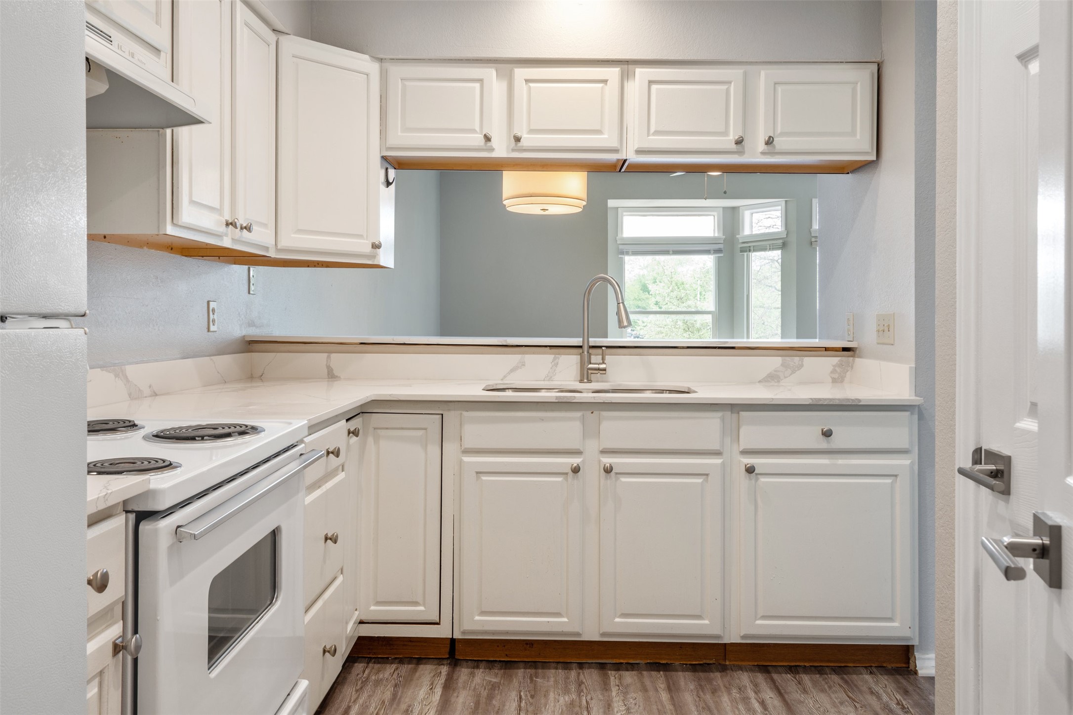 5303 Indio Cove, Unit A Austin, TX 78745 - Photo 9 of 15 a kitchen with stainless steel appliances granite countertop white cabinets and sink