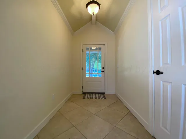 a room with a table and a chandelier