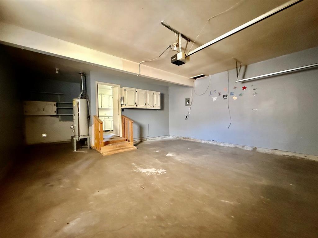 1114 Davis Street Cleburne, TX 76033 - Photo 11 of 17 a view of empty room with fireplace and windows