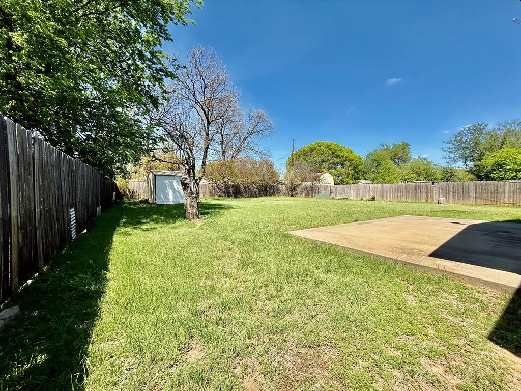 1114 Davis Street Cleburne, TX 76033 - Photo 12 of 17 a view of a yard with an trees