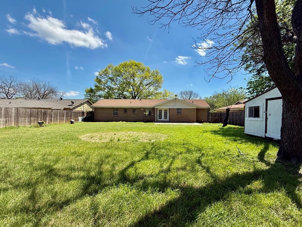 1114 Davis Street Cleburne, TX 76033 - Photo 15 of 17 a front view of a house with garden