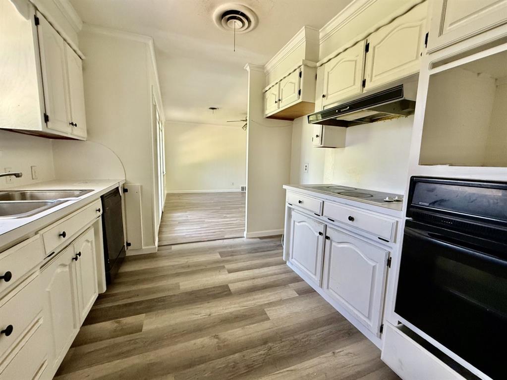 1114 Davis Street Cleburne, TX 76033 - Photo 4 of 17 a kitchen with cabinets and a stove