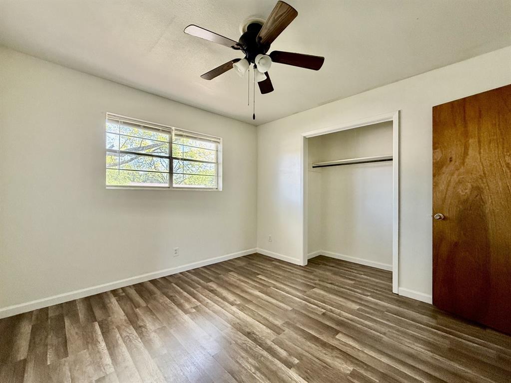 1114 Davis Street Cleburne, TX 76033 - Photo 5 of 17 a view of room with ceiling fan and wooden floor