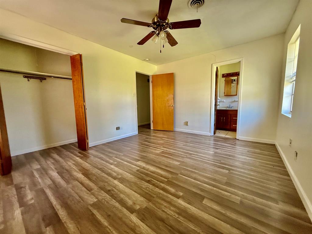 1114 Davis Street Cleburne, TX 76033 - Photo 7 of 17 wooden floor in an empty room with a window