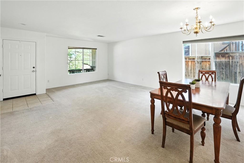 32610 Ridge Top Lane Castaic, CA 91384 - Photo 11 of 47 a view of a dining room with furniture and a chandelier
