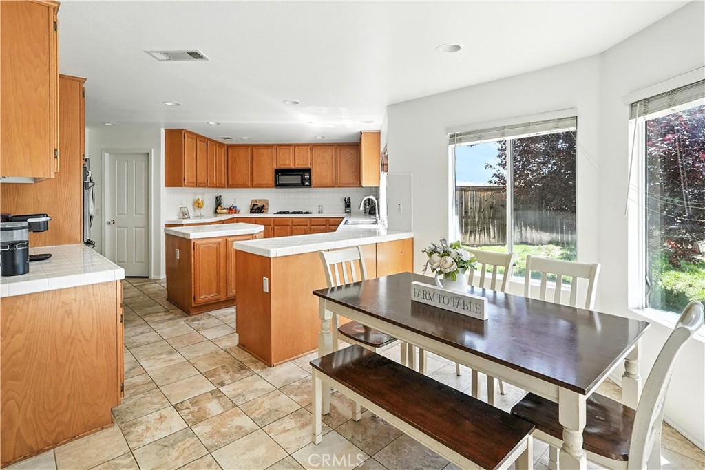 32610 Ridge Top Lane Castaic, CA 91384 - Photo 17 of 47 a dining hall with stainless steel appliances a dining table and chairs