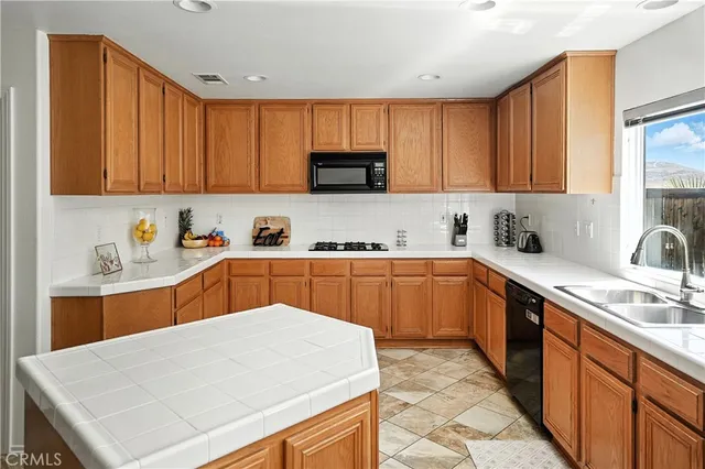 a kitchen with stainless steel appliances a sink dishwasher refrigerator stove and sink