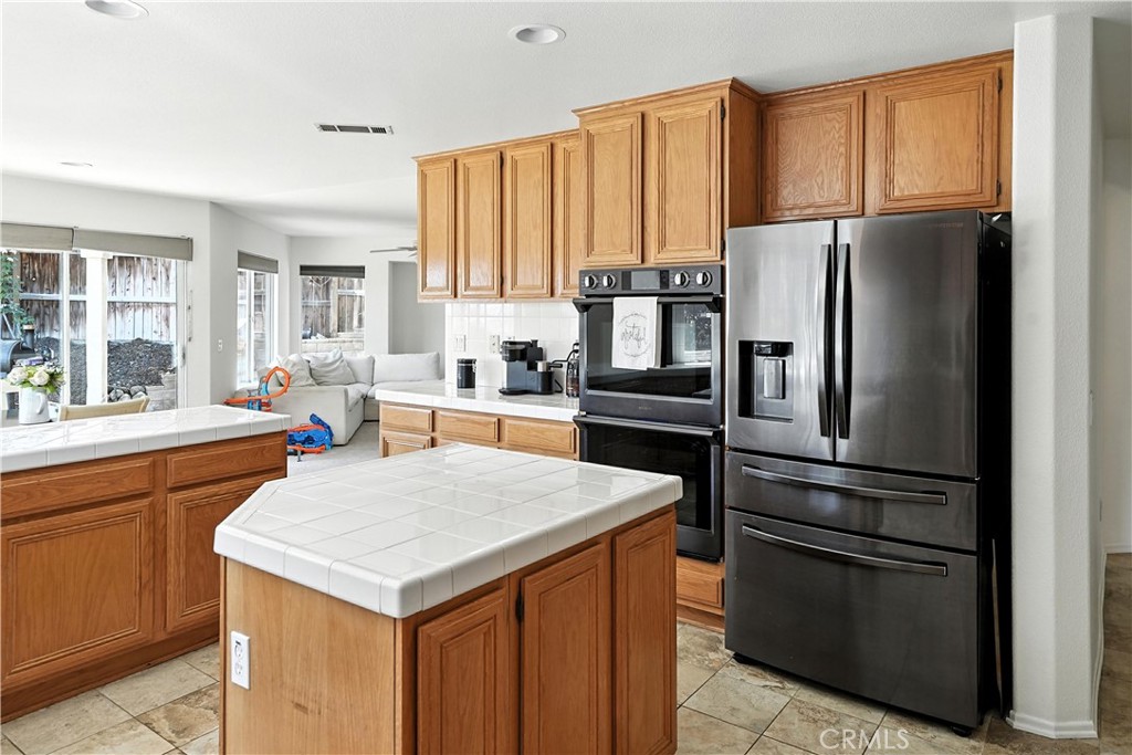 32610 Ridge Top Lane Castaic, CA 91384 - Photo 20 of 47 a kitchen with a refrigerator a stove a sink and a microwave