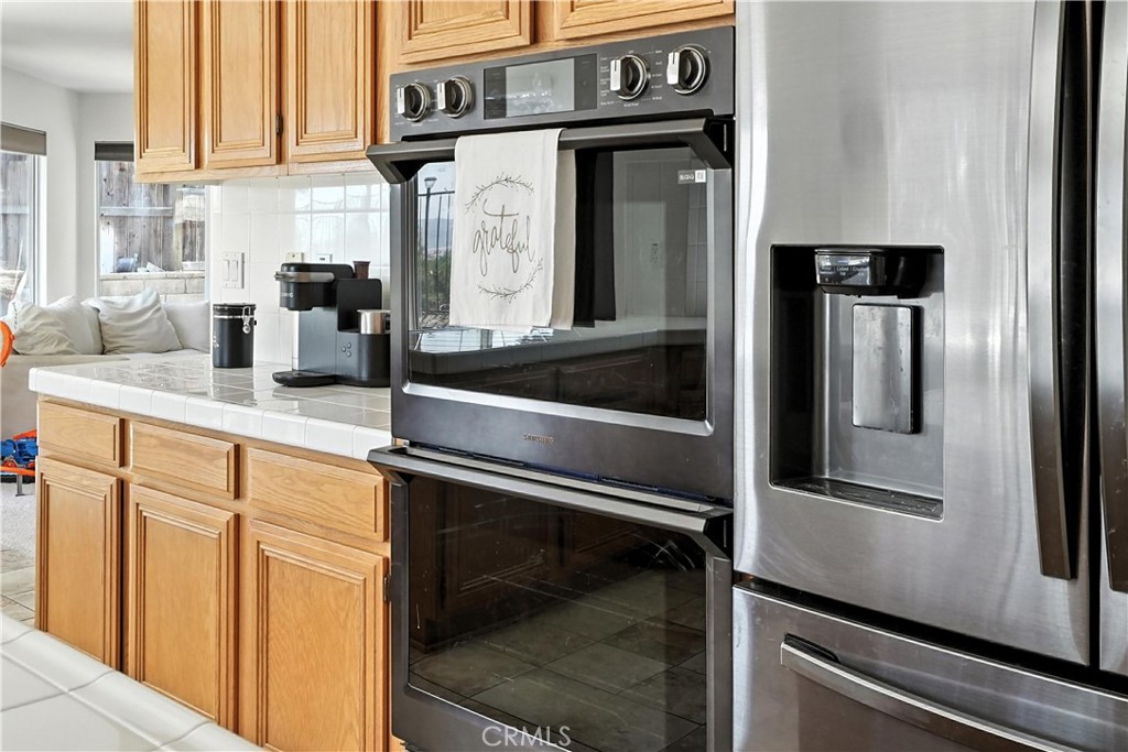32610 Ridge Top Lane Castaic, CA 91384 - Photo 21 of 47 a kitchen with stainless steel appliances granite countertop a refrigerator and a sink