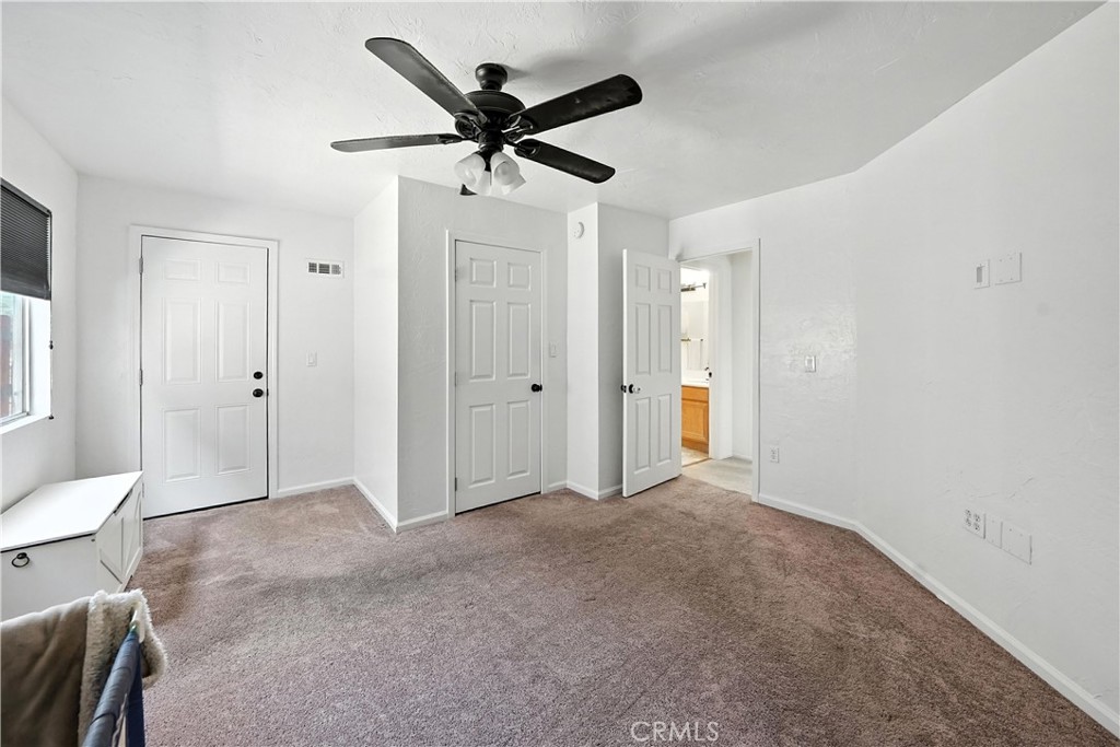 32610 Ridge Top Lane Castaic, CA 91384 - Photo 29 of 47 a view of a livingroom with a ceiling fan & a ceiling fan