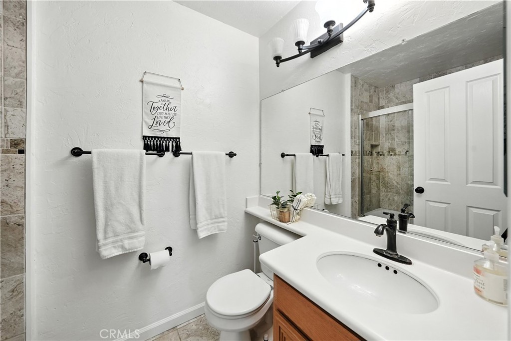32610 Ridge Top Lane Castaic, CA 91384 - Photo 30 of 47 a bathroom with a sink toilet and shower