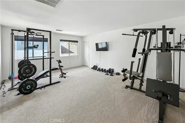 a room with gym equipment and a window
