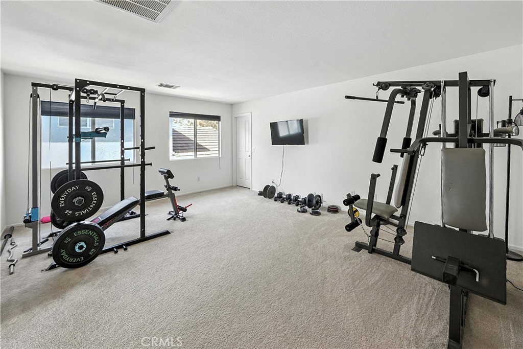 32610 Ridge Top Lane Castaic, CA 91384 - Photo 32 of 47 a room with gym equipment and a window