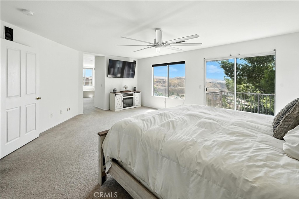 32610 Ridge Top Lane Castaic, CA 91384 - Photo 35 of 47 a spacious bedroom with a large bed and a flat screen tv