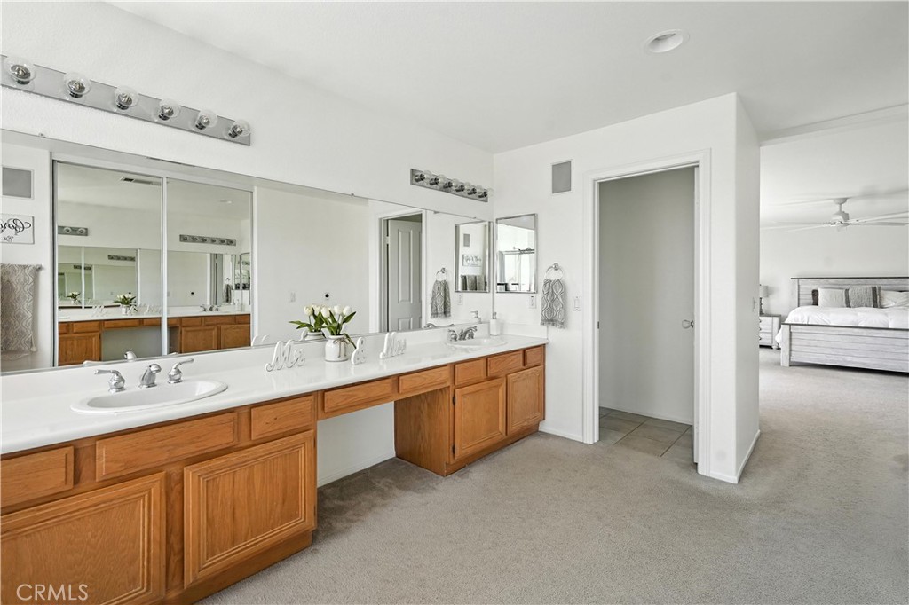 32610 Ridge Top Lane Castaic, CA 91384 - Photo 37 of 47 a spacious bathroom with a granite countertop sink mirror and a