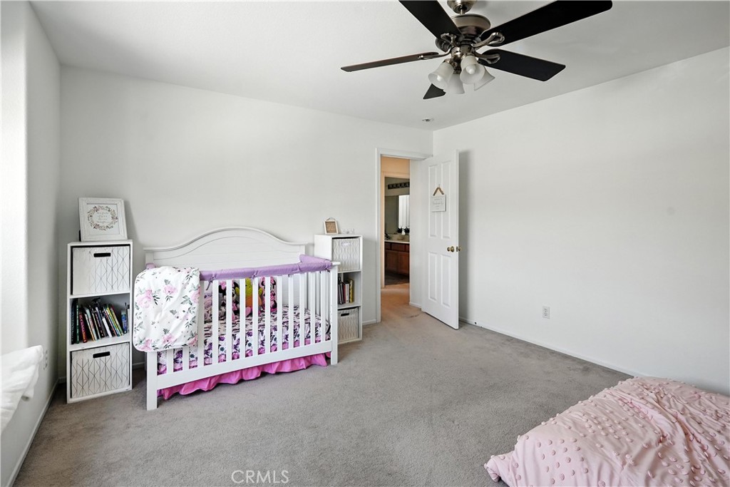 32610 Ridge Top Lane Castaic, CA 91384 - Photo 40 of 47 a bedroom with a bed and a chandelier