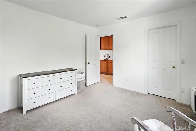 a view of room with cabinet and mirror