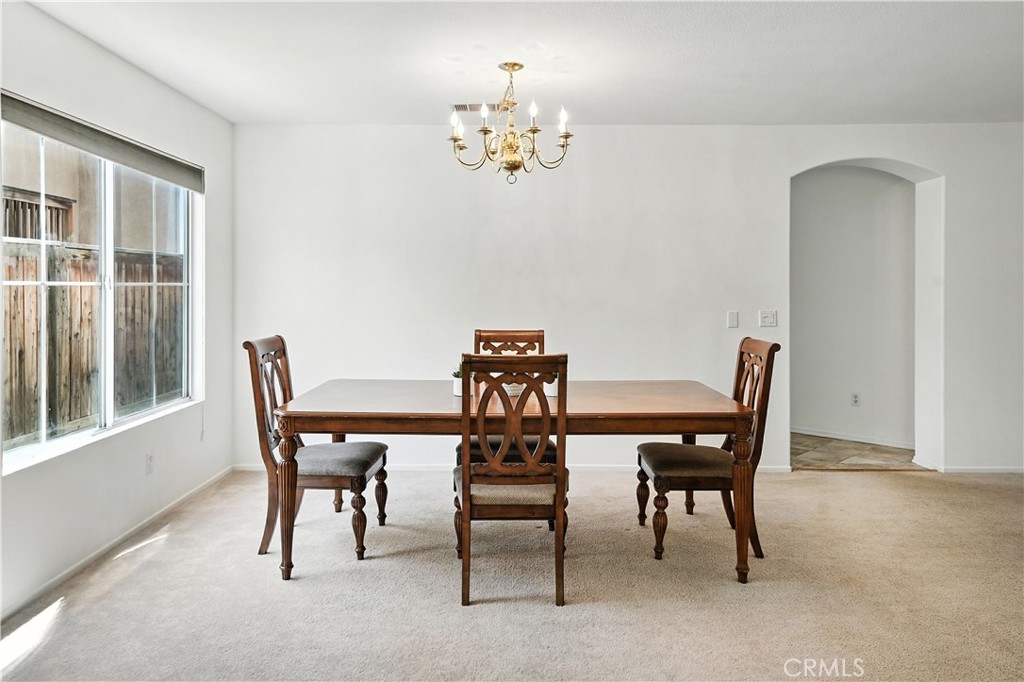 32610 Ridge Top Lane Castaic, CA 91384 - Photo 10 of 47 a view of a dining room with furniture and chandelier