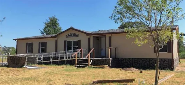 a view of a house with a yard and wooden fence