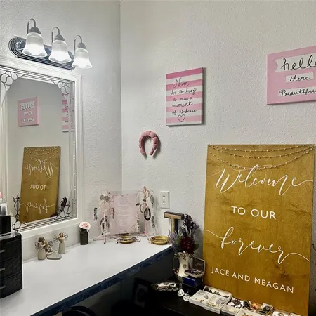 a bathroom with a sink mirror and vanity