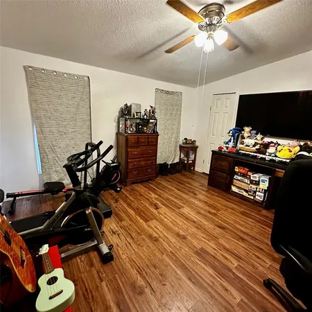 a bedroom with furniture and flat screen tv