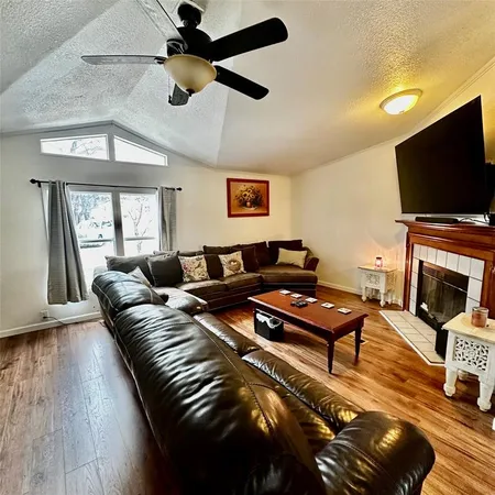 a living room with furniture a flat screen tv and a fireplace