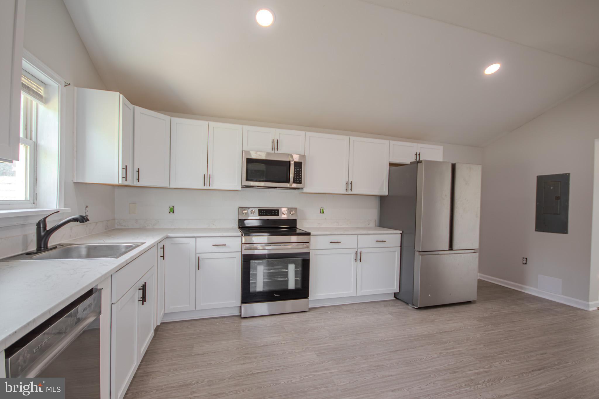 5693 Landon Store Road Marion Station, MD 21838 - Photo 2 of 20 a kitchen with a sink stove and refrigerator
