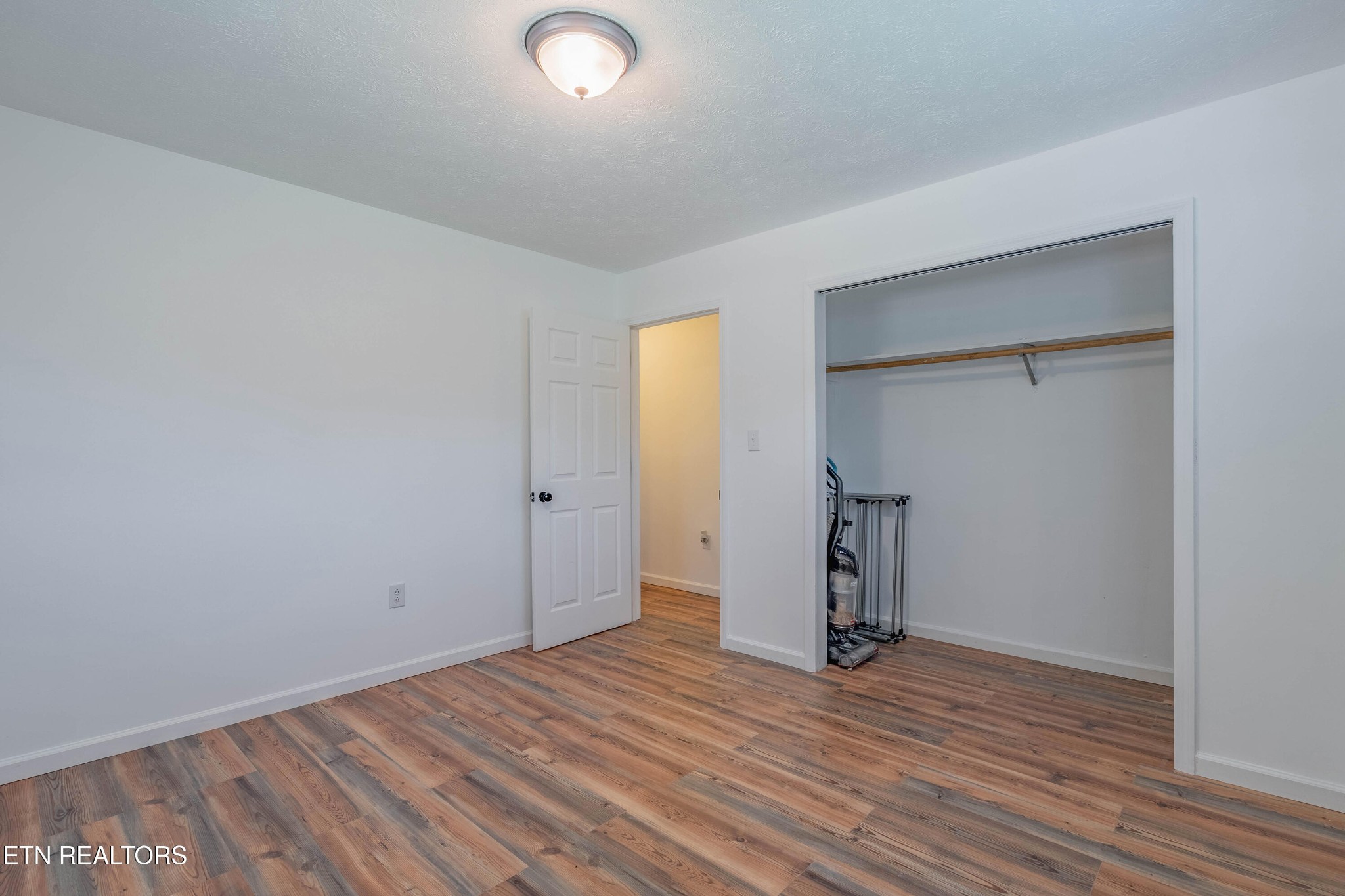 104 Apricot Road Cosby, TN 37722 - Photo 20 of 31 an empty room with wooden floor and closet