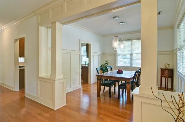 a view of a dining room with furniture window and wooden floor